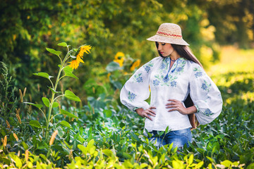 model stands in fashionable embroidered clothes from the designer