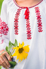 flax shirt with a red pattern for girls on the background of the sunflower