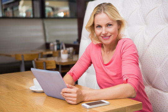 Woman having a coffee using tablet