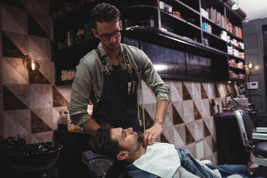 Barber putting towel over clients neck