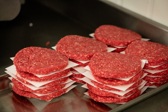 Raw hamburger patties in shop