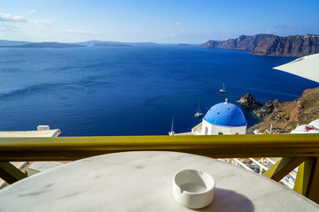 Beautiful deep blue Aegean ocean panoramic sea view and blue church roof from breakfast coffee shop...