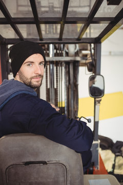 Portrait of man sitting in forklift truck