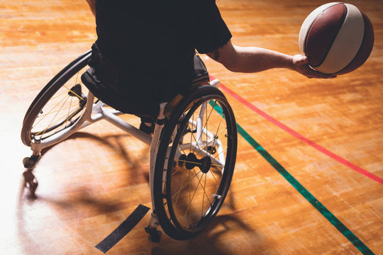 Disabled man practicing basketball in the court