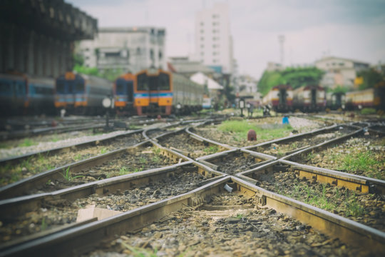 Railway track, line crossing railway track in railway station background.