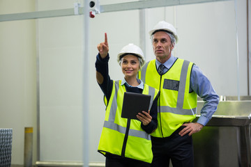 Two technician discussing over digital tablet