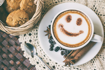 Smile face drawing on latte art coffee, vintage style