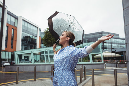 Beautiful woman enjoying rain