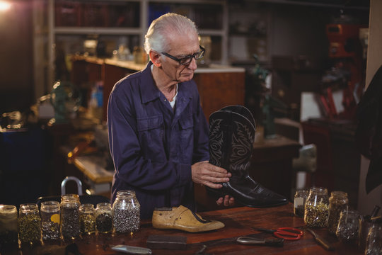 Senior cobbler working in workshop