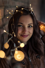 portrait of a beautiful young woman holding little lights