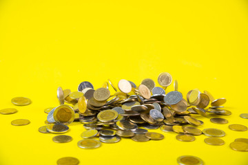 Falling coins money on yellow background, business wealth concept.