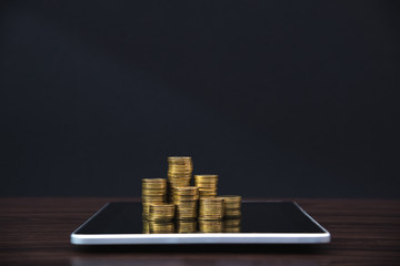 Coins stacks with tablet computer and financial graph, business planning vision and finance analysis concept