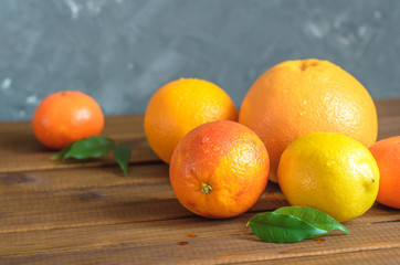 Fresh citrus fruits on wooden table.