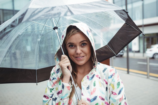 Portrait of beautiful woman holding umbrella
