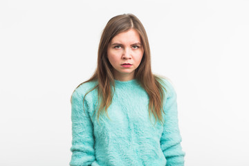 Portrait of angry woman standing on white background