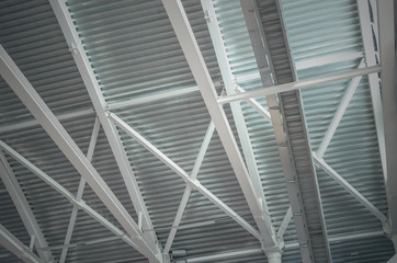 Steel structure (skeleton) with corrugated board (proflinite) of the ceiling of an industrial building.