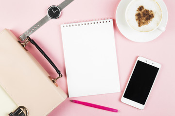 Concept morning planning - cappuccino, notebook, pen, phone, watch, bag on pink background. Top view, copy space