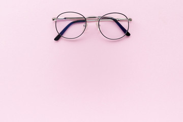 Minimal composition with glasses on a pink pastel background