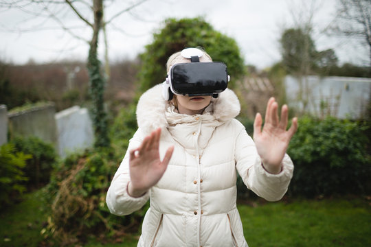 Woman in fury coat using virtual reality headset