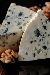Wedges of soft blue cheese with walnuts.