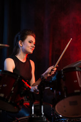 Fototapeta na wymiar Female drummer at rock concert