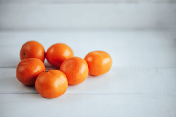 Mandarin orange. Tangerines on a white wooden table