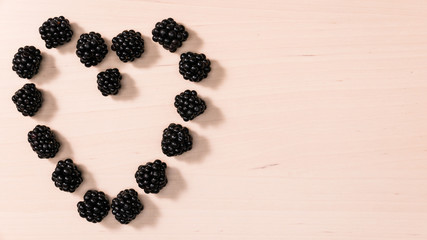 Fresh berries of blackberry in form heart