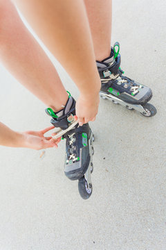 Woman putting roller skates on