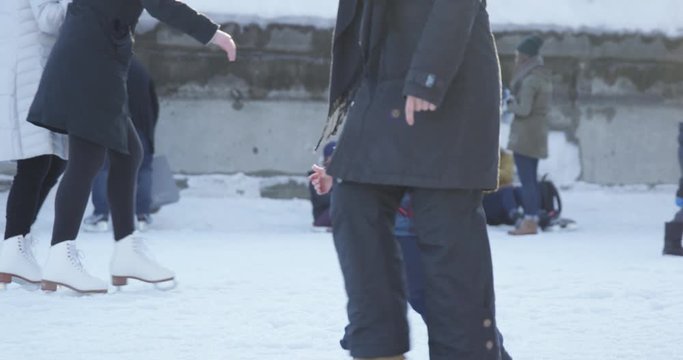 Toddler and mother walk along rideau canal during winter festival - side profile