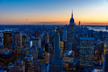 Fototapeta na wymiar New York City skyline at night - skyscrapers of midtown Manhattan with Empire State Building at Amazing Sunset - USA