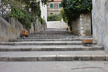 Fototapeta na wymiar Narrow alleys with stone stairs between old brick houses In Split, Croatia