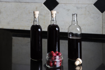 Three bottles of red cherry wine