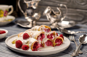 Pancakes with raspberries on a beautifully laid table