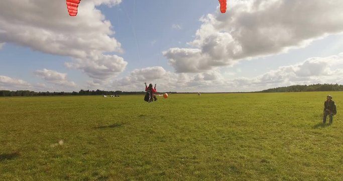 Aerial view of takes off the paraglider with a parachute from the ground on a sunny day.