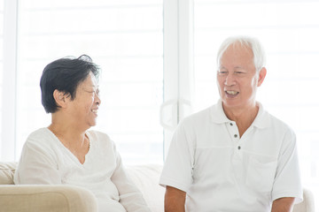 Old couple talking at home