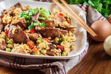 Fried rice with chicken and vegetables served on a plate