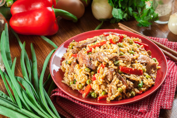 Fried rice with chicken and vegetables served on a plate