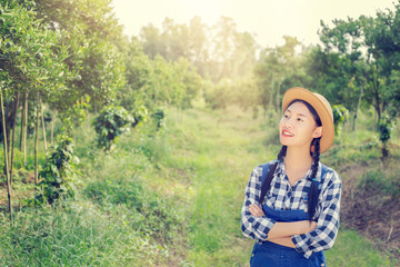 happy asia farmer posing in a orange Garden