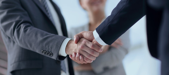 closeup of handshake of business partners - obrazy, fototapety, plakaty