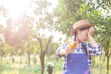 Sad farmer holding Tangerine Rotten