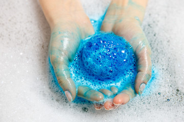 Blue ball of bath salts. Bath salt ball dissolves in the hands. Bomb. Foam.