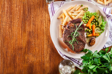 Beef steak served with baked potatoes
