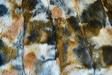 Close up of motley fake fur. Texture. Background