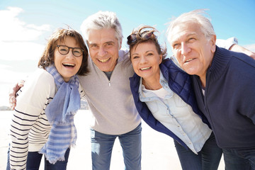 Portrait of cheerful senior people having fun on vacation