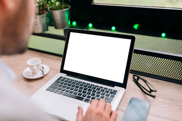 Close-up image of a white laptop screen. Working on a laptop at the cafe.