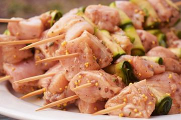 Raw Marinated Chicken Meat Skewers. Barbeque Summer Picnic Food. Grilled Meat over Wooden Background with Spices