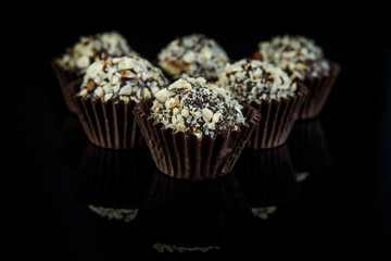 closeup big chocolate candies on black background