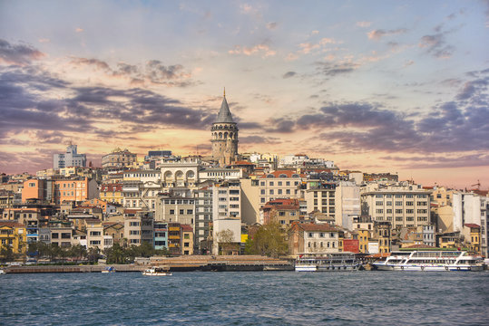 Scenery of Galata district with the famous Galata Tower over the Golden Horn, Istanbul, Turkey at sunset. Galata Tower is one of main travel attractions in the city. 