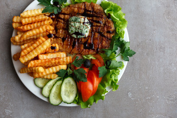 French fries steak vegetables salad