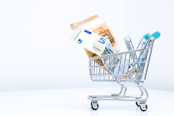 shopping cart with isolated money on white background